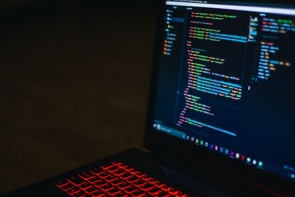 Laptop with code on screen and a red backlit keyboard, illustrating reviewing a Claude Code mod before installing it