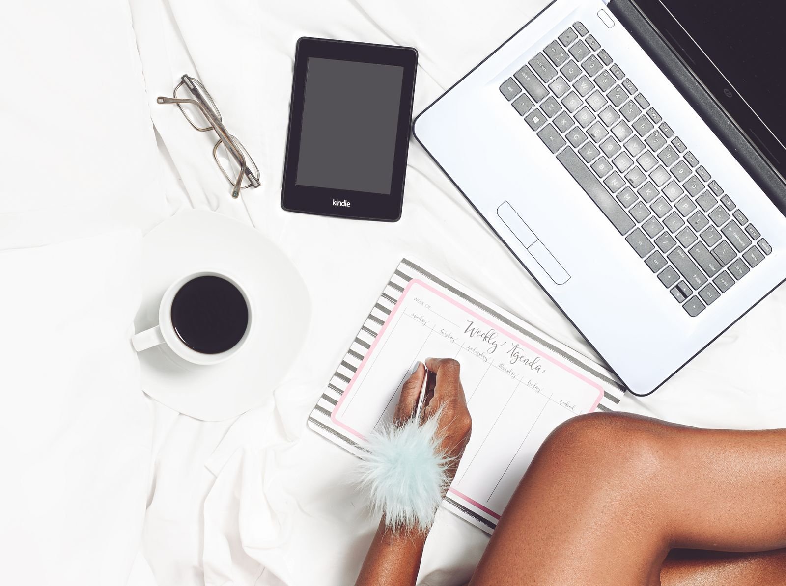 Laptop, planner and coffee on a desk, the kind of morning setup a daily AI brief is meant to replace