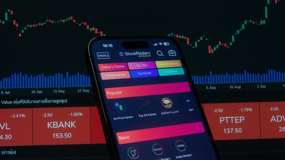 Smartphone showing a trading app with market charts, illustrating Coinbase options access