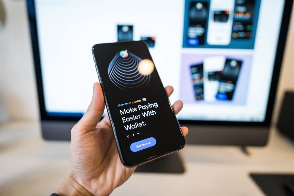 Hand holding a smartphone showing a digital wallet app, illustrating withdrawing stablecoins to an external wallet