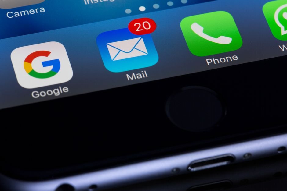 Smartphone home screen with the Mail app, where DoorDash settlement notices will arrive