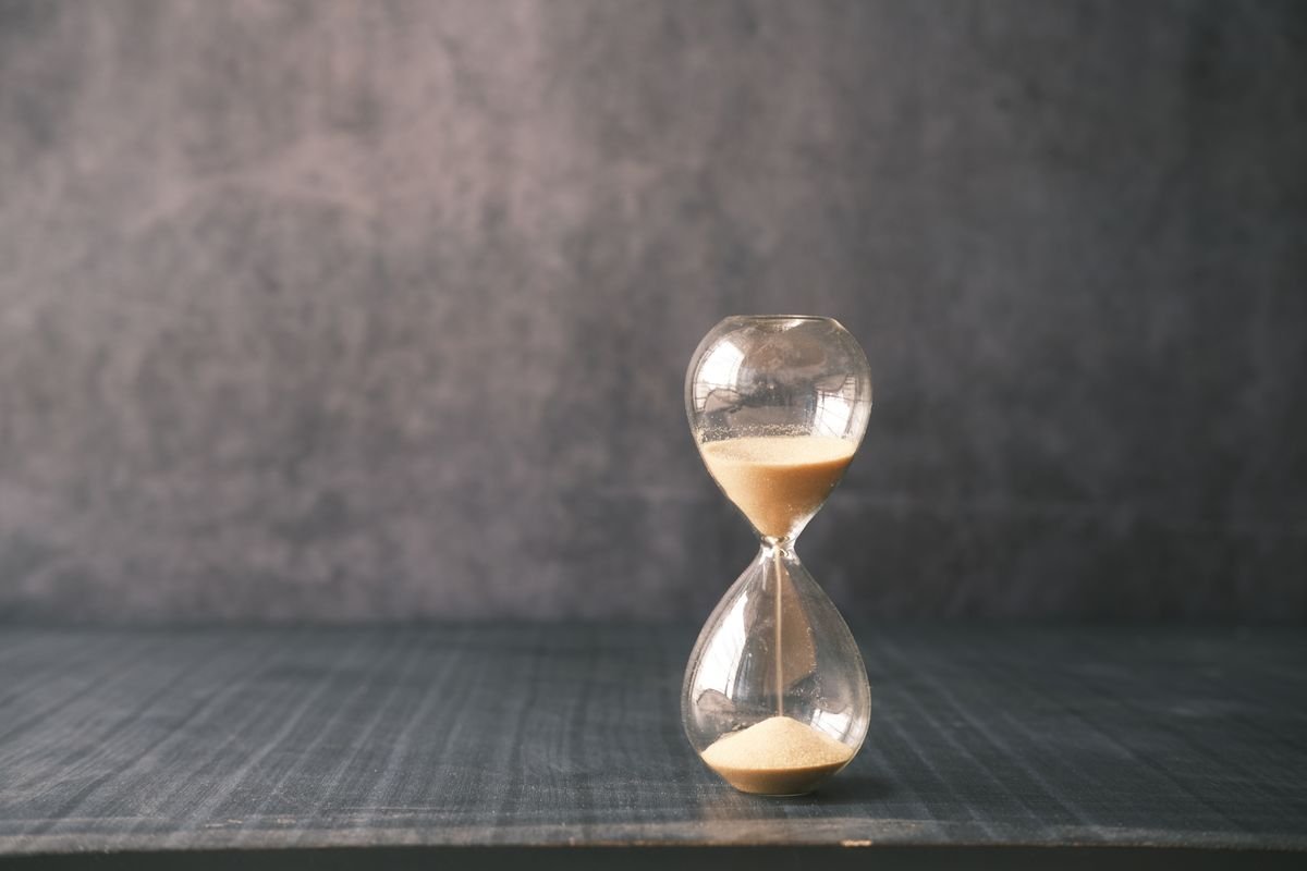 Hourglass with sand passing, illustrating hourly perpetual funding payments