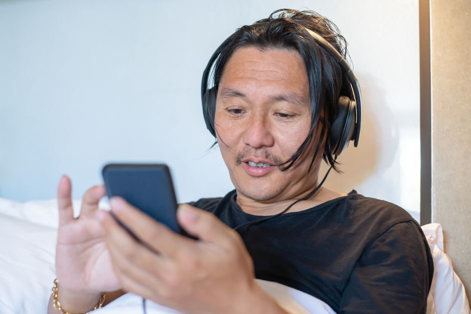 Phone and headphones ready to stream a new K-pop mini album