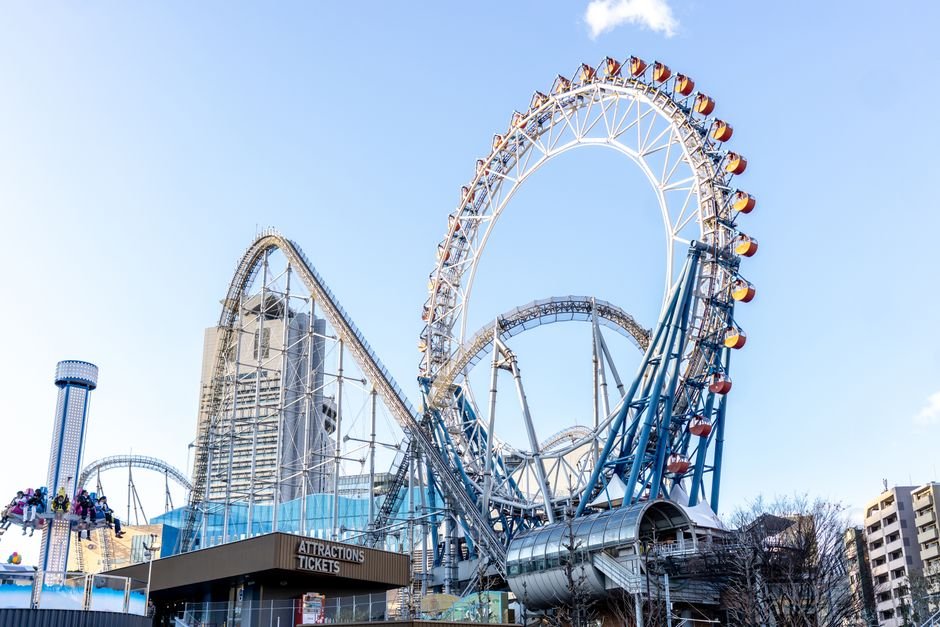 Ferris wheel and roller coaster at an amusement park in daytime