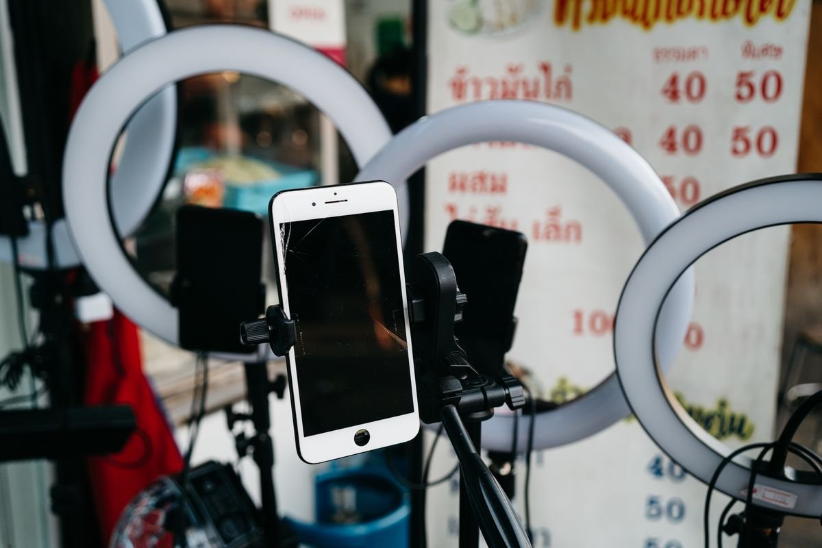 Smartphone on a tripod with ring lights, the typical setup for Whatnot or eBay Live card breaks