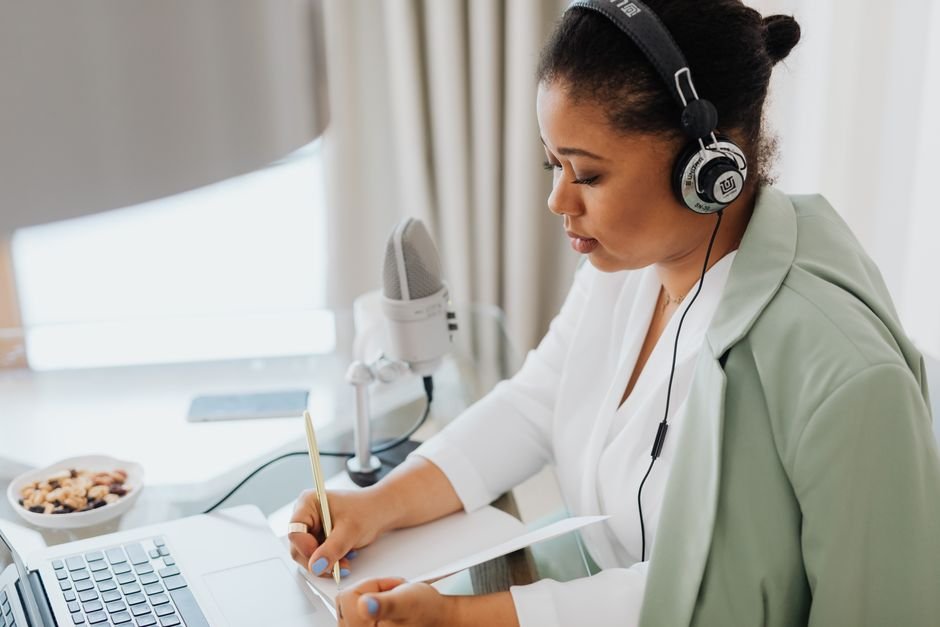 Person with headphones checking a ChatGPT meeting transcript against the original recording