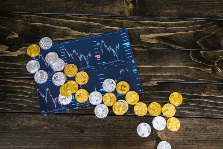 Gold and silver cryptocurrency coins on a trading chart, illustrating the Monad MON token unlock