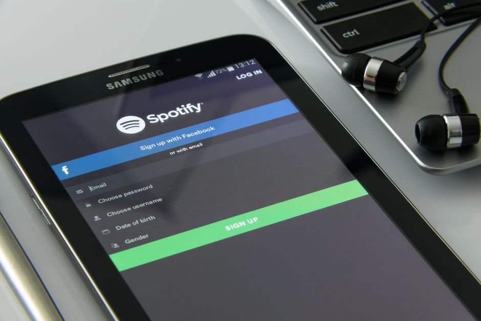 Headphones and a phone streaming a new K-pop release
