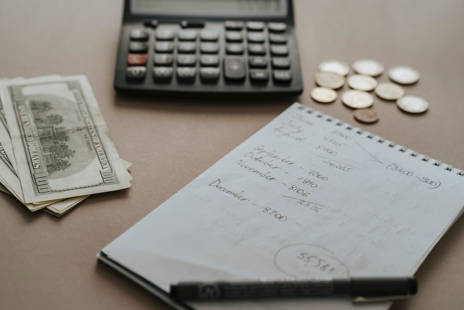 Calculator and notebook used to compare subscription costs