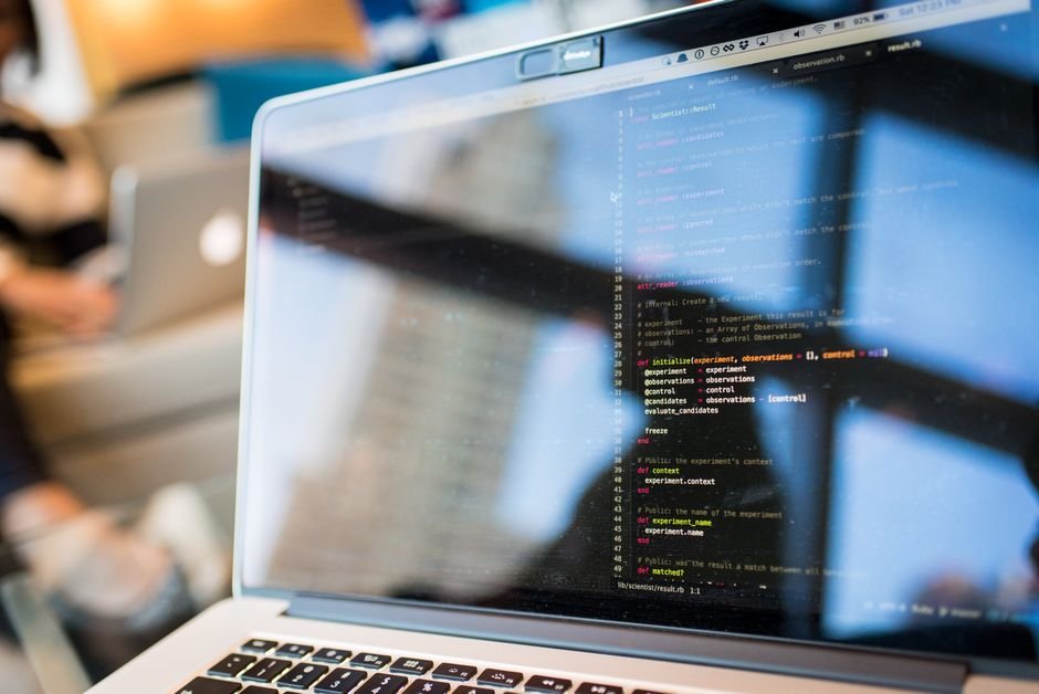Developer reviewing API code on a laptop before swapping model names