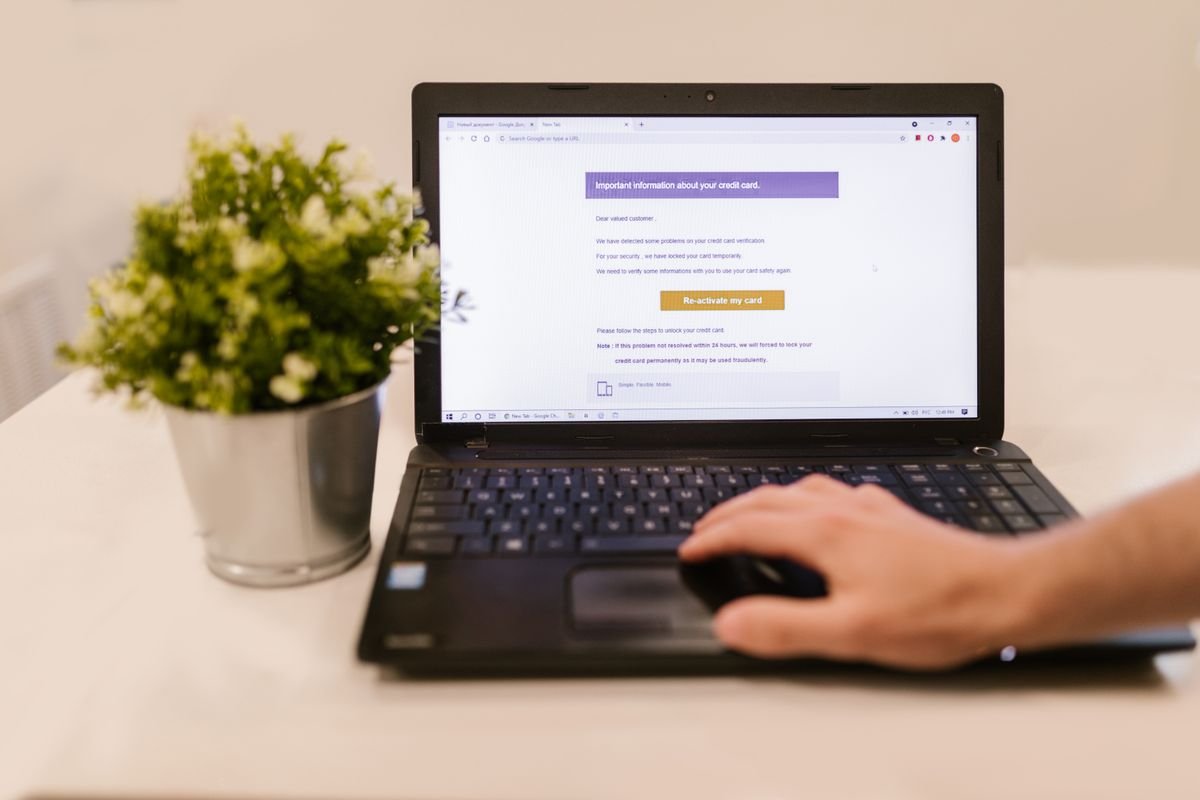 Person reading email on a laptop, the main security exposure for unsupported Office 2021 Outlook
