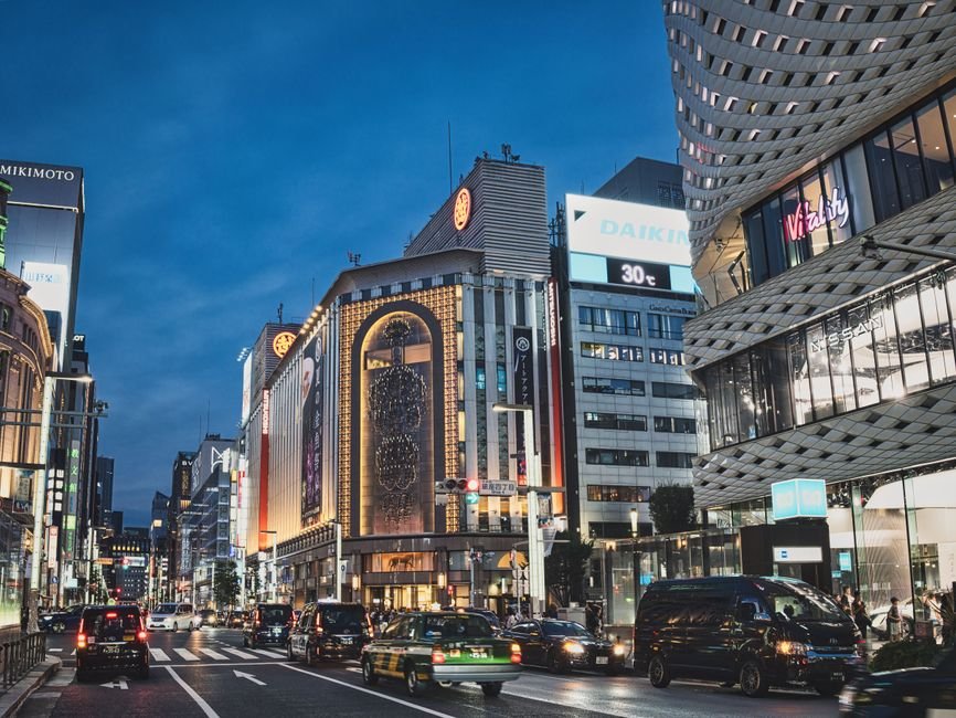 Tokyo street at night where many hotels collect the local accommodation tax