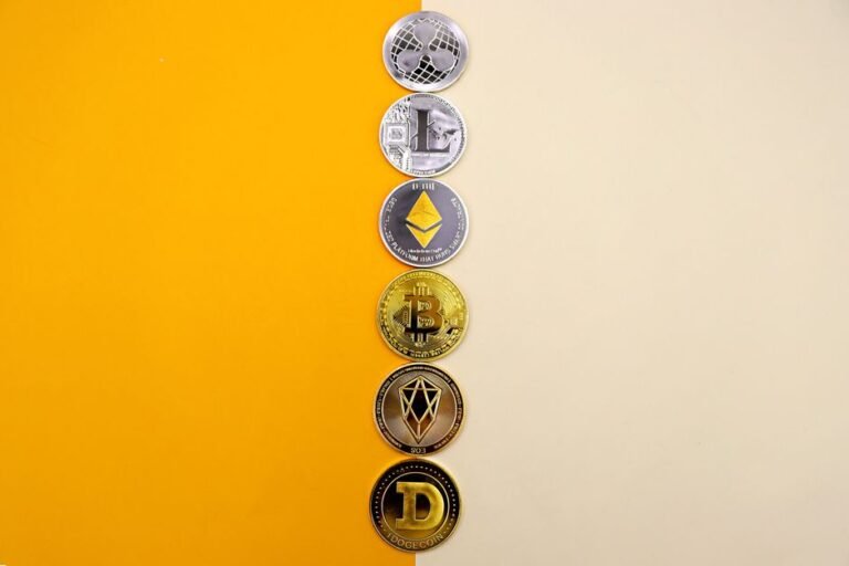 Row of cryptocurrency coins on a yellow surface