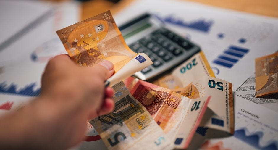 Calculator next to banknotes for working out ATM withdrawal fees