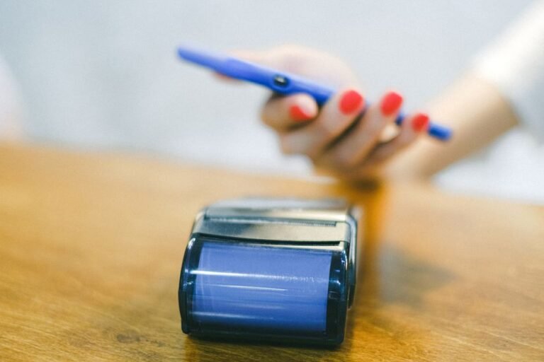 Hand using a smartphone for a contactless payment at a terminal