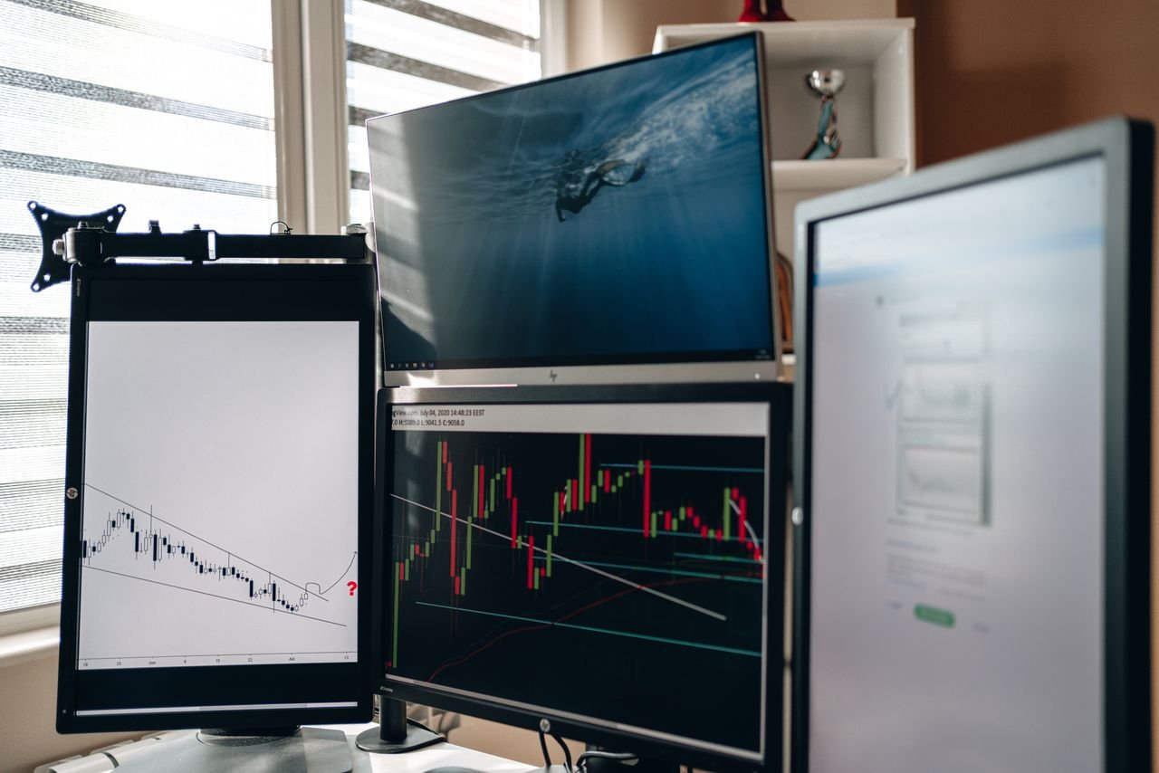 Home office with multiple monitors showing futures charts, the setup for weekend CME bitcoin futures trading