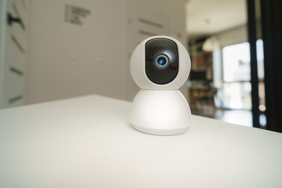 Smart home security camera on a table indoors, illustrating Wyze Indoor Cam Pan setup failures